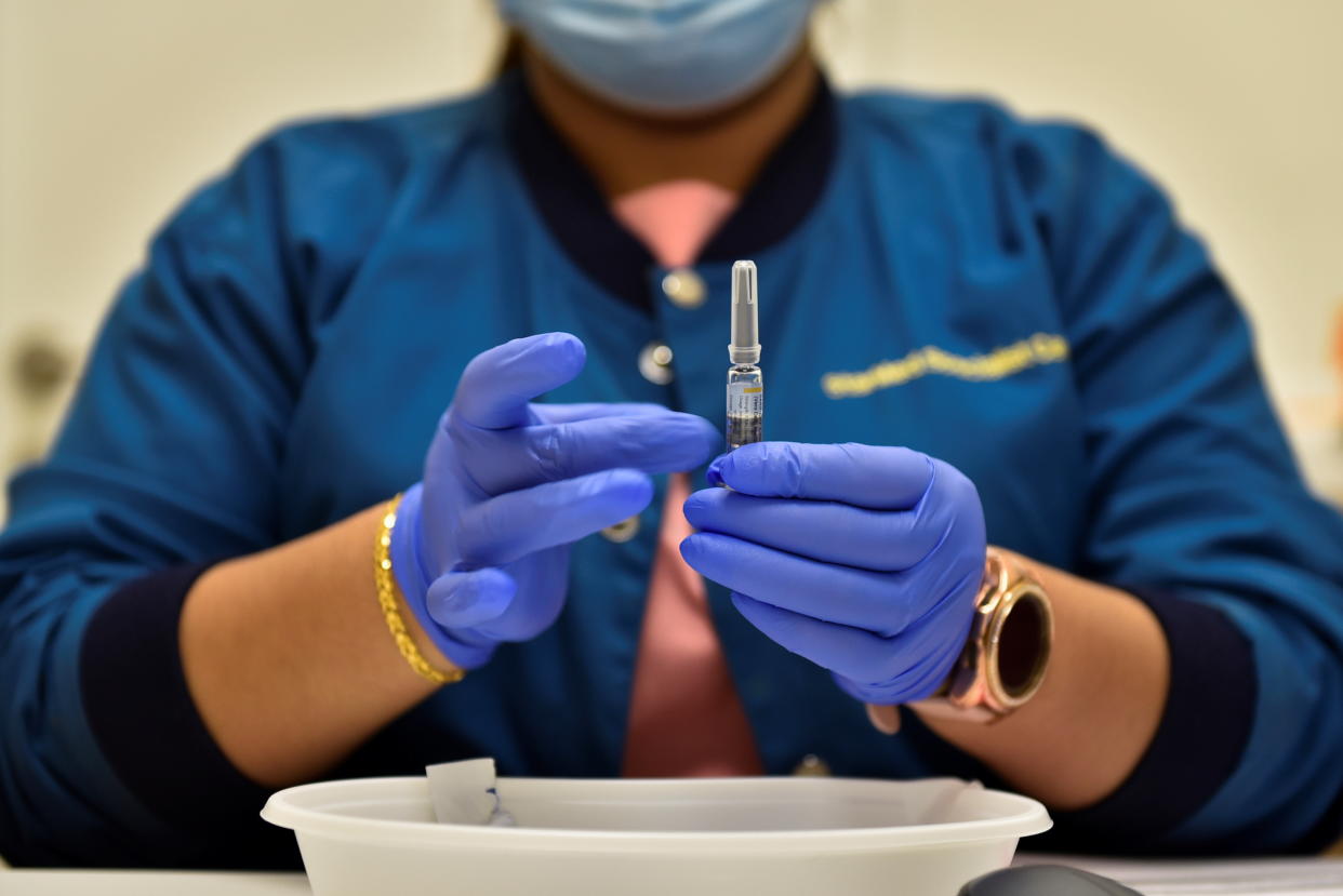 Nurl Anisah, a nurse at StarMed Specialist Centre, prepares to administer the Sinovac vaccine to a patient, in Singapore July 13, 2021. REUTERS/Caroline Chia