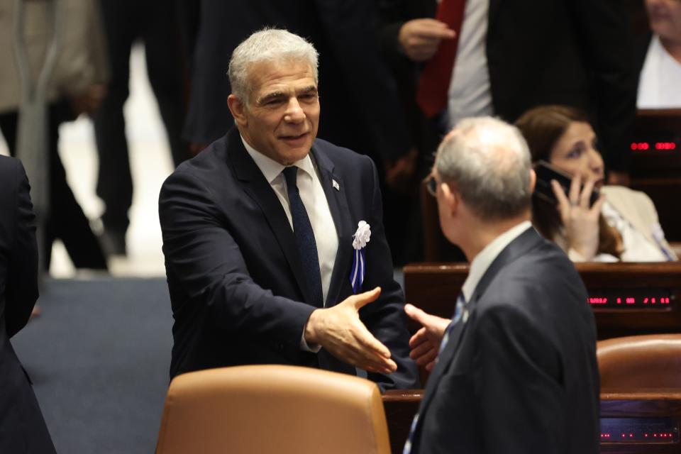 Israeli outgoing Prime Minister Yair Lapid is seen during the swearing-in ceremony for Israeli lawmakers at the Knesset, Israel's parliament, in Jerusalem, Tuesday, Nov. 15, 2022. Israeli lawmakers were sworn in at the Knesset, on Tuesday, following national elections earlier this month. (Abir Sultan/Pool Photo via AP)