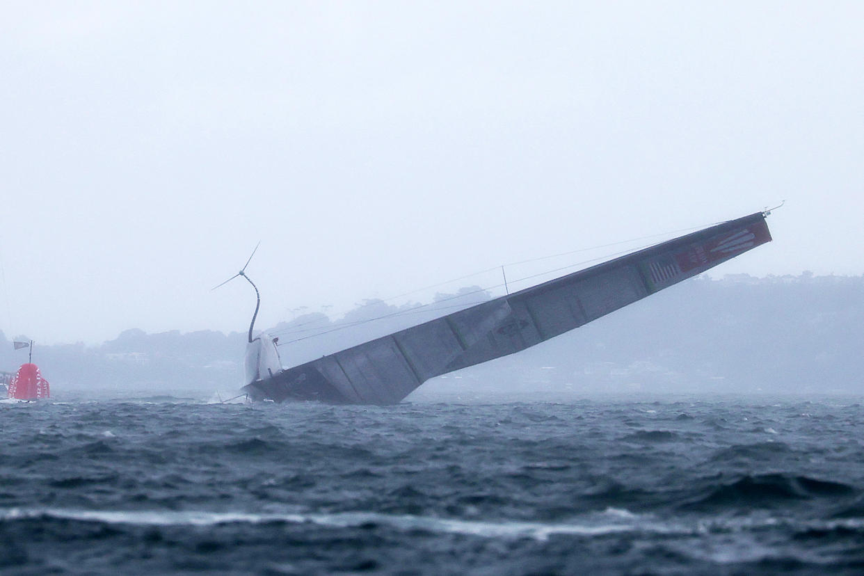 American Magic capsizes in their race against Prada Luna Rosa during the America's Cup challenger series, the Prada Cup.