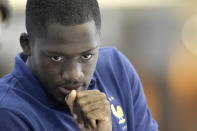 Ibrahima Konate arrives to answer reporters during a press conference at the Jassim Bin Hamad stadium in Doha, Qatar, Saturday, Nov. 19, 2022, ahead of the upcoming World Cup. France will play their first match in the World Cup against Australia on Nov. 22. (AP Photo/Christophe Ena)