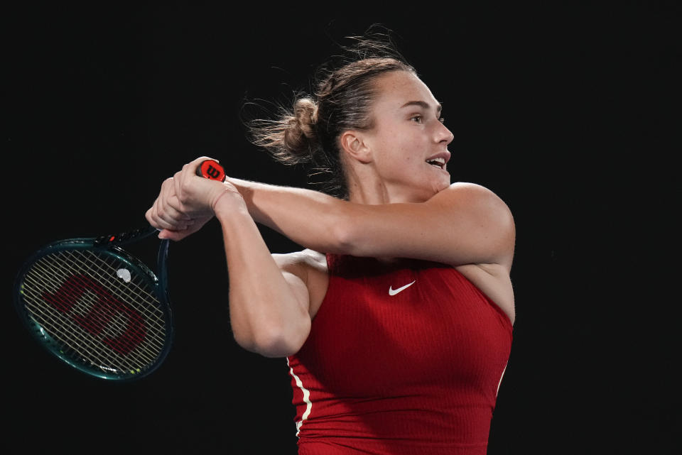 Aryna Sabalenka of Belarus plays a backhand return to Germany's Ella Seidel during their first round match at the Australian Open tennis championships at Melbourne Park, Melbourne, Australia, Monday, Jan. 15, 2024. (AP Photo/Andy Wong)