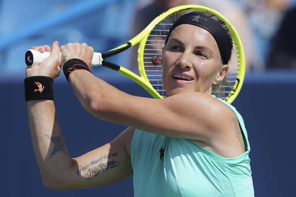 Svetlana Kuznetsova, of Russia, returns to Ashleigh Barty, of Australia, during the Western & Southern Open tennis tournament, Saturday, Aug. 17, 2019, in Mason, Ohio. (AP Photo/John Minchillo)