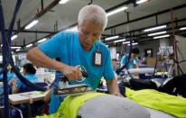 Hoang Van The, 52, who joined X40 garment company and now Maxport since 1987, works at Maxport garment company in Hanoi
