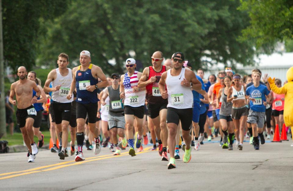 Runners begin the half marathon in the Hungry Duck Run in Brighton on Monday, July 4, 2022.
