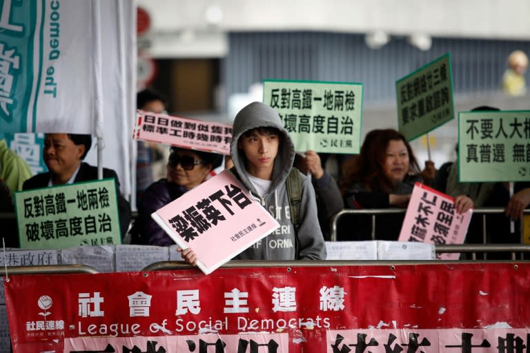 Protesters outside the Legislative Council before Hong Kong's Chief Executive Leung Chun-ying delivers his 2016 policy address in Hong Kong on January 13, 2016