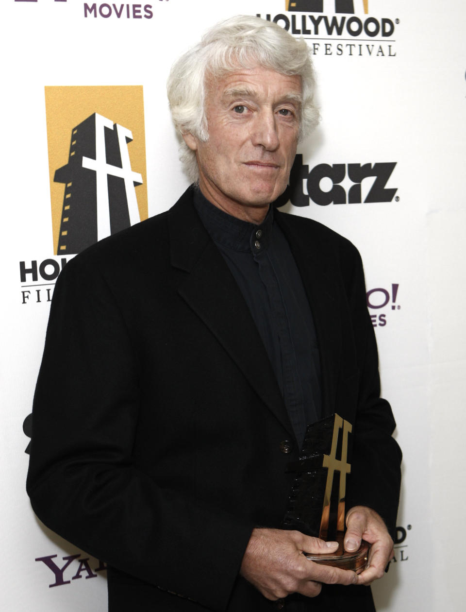 FILE - In this Oct. 26, 2009 file photo, Roger Deakins poses with his award for best cinematographer backstage at the 13th Annual Hollywood Awards Gala, in Beverly Hills, Calif. (AP Photo/Matt Sayles, File)