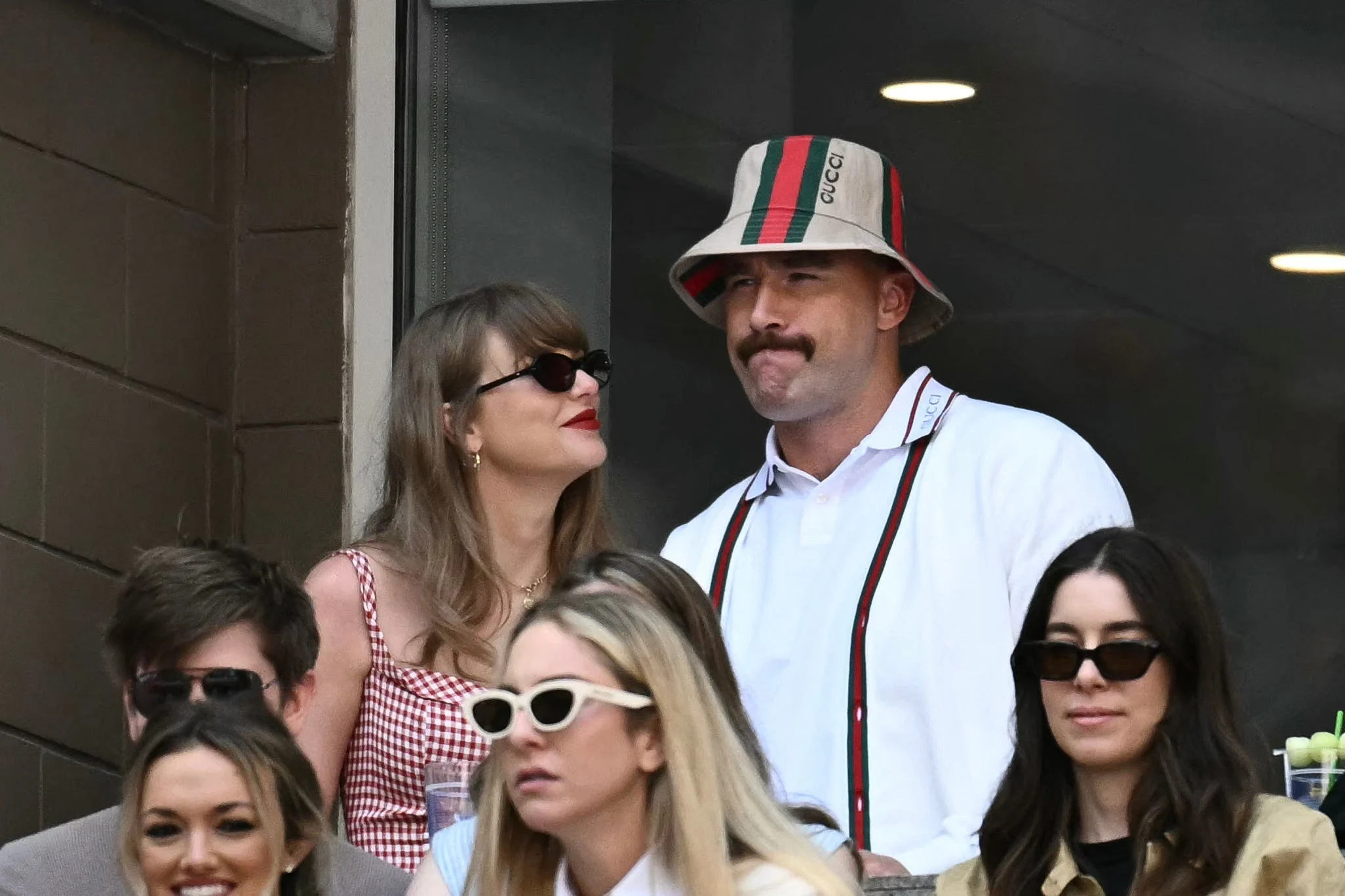 (L-R, back row) US musician Taylor Swift and US NFL football player Travis Kelce attend the men's final match between Italy's Jannik Sinner and USA's Taylor Fritz on day fourteen of the US Open tennis tournament at the USTA Billie Jean King National Tennis Center in New York City, on September 8, 2024. (Photo by ANGELA WEISS / AFP) (Photo by ANGELA WEISS/AFP via Getty Images) ORG XMIT: 776152839 ORIG FILE ID: 2170221742