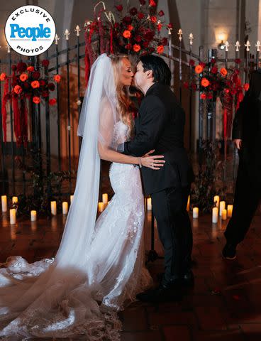 <p>DeAngelo Castro for SYMBOLL</p> Nita Strauss and Josh Villalta seal their union with a kiss at their wedding