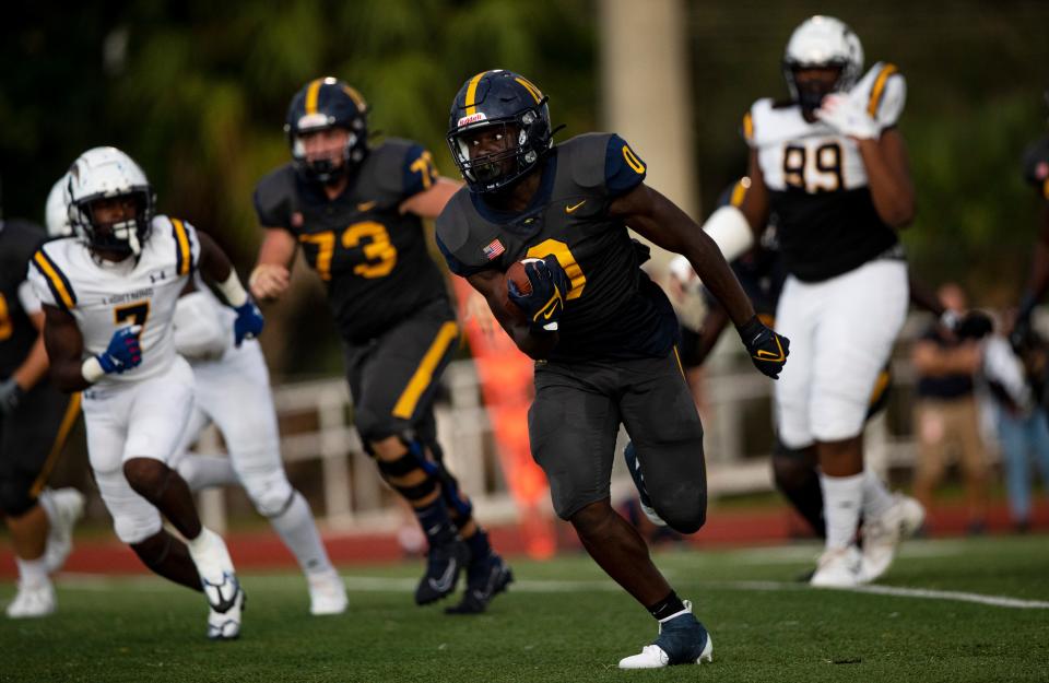 Kendrick Raphael of the Naples High School football team runs for a touchdown against Lehigh in Naples on Friday, August 26, 2022. Naples won 45-9.  