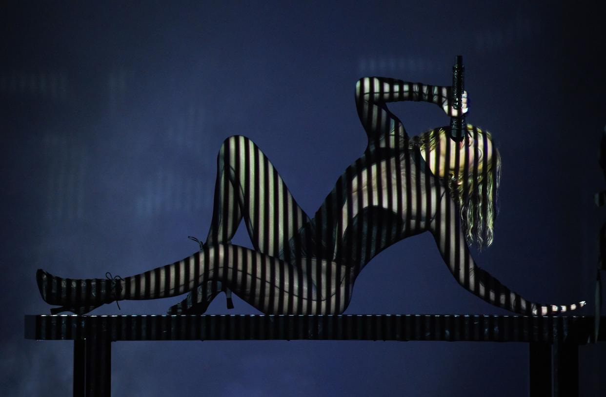 Jennifer Lopez performs in a black bodysuit during the 2020 American Music Awards on Sunday, Nov. 22, 2020.