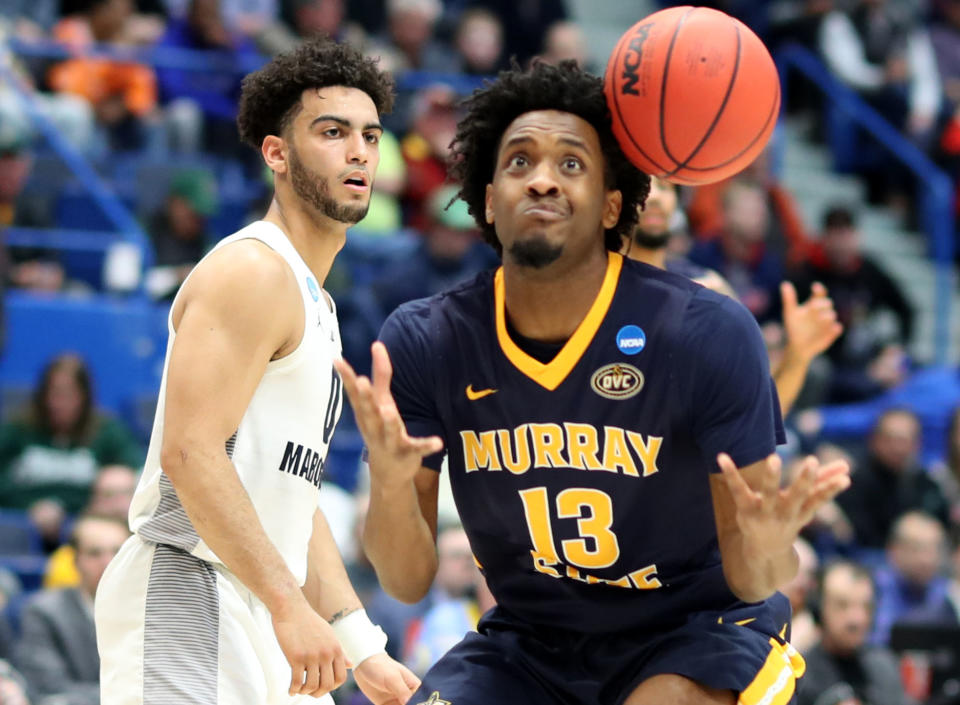 <p>Markus Howard #0 of the Marquette Golden Eagles watches as Devin Gilmore #13 of the Murray State Racers misses the ball during the first round game of the 2019 NCAA Men’s Basketball Tournament at XL Center on March 21, 2019 in Hartford, Connecticut. (Photo by Rob Carr/Getty Images) </p>
