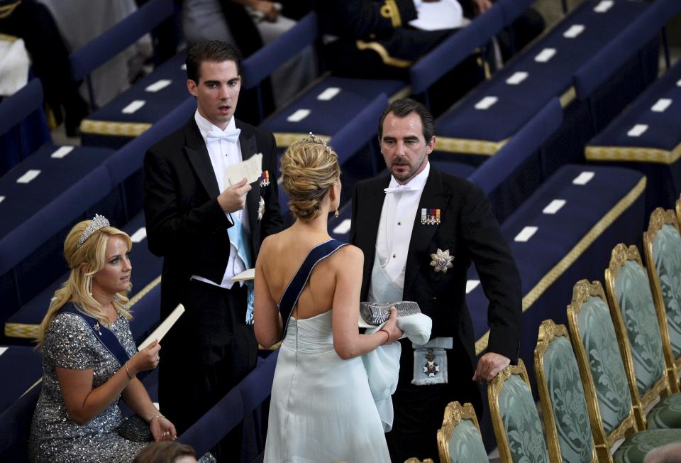 Prince Nikolaos of Greece and his wife Tatiana take their seats in the Royal Chapel before the wedding of Sweden's Princess Madeleine and Christopher O'Neill, in Stockholm Saturday June 8, 2013 at the Royal Chapel of the palace. (AP Photo/Anders Wiklund) ** SWEDEN OUT **