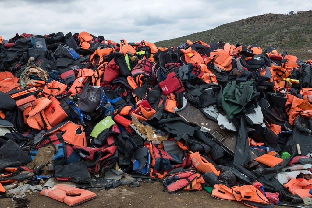 Tens of thousands of life jackets abandoned by refugees fleeing wars in the Middle East and beyond, lay in piles in a landfill in Molyvos, Lesbos, Greece on March 15, 2016. (Darren Ell - image credit)