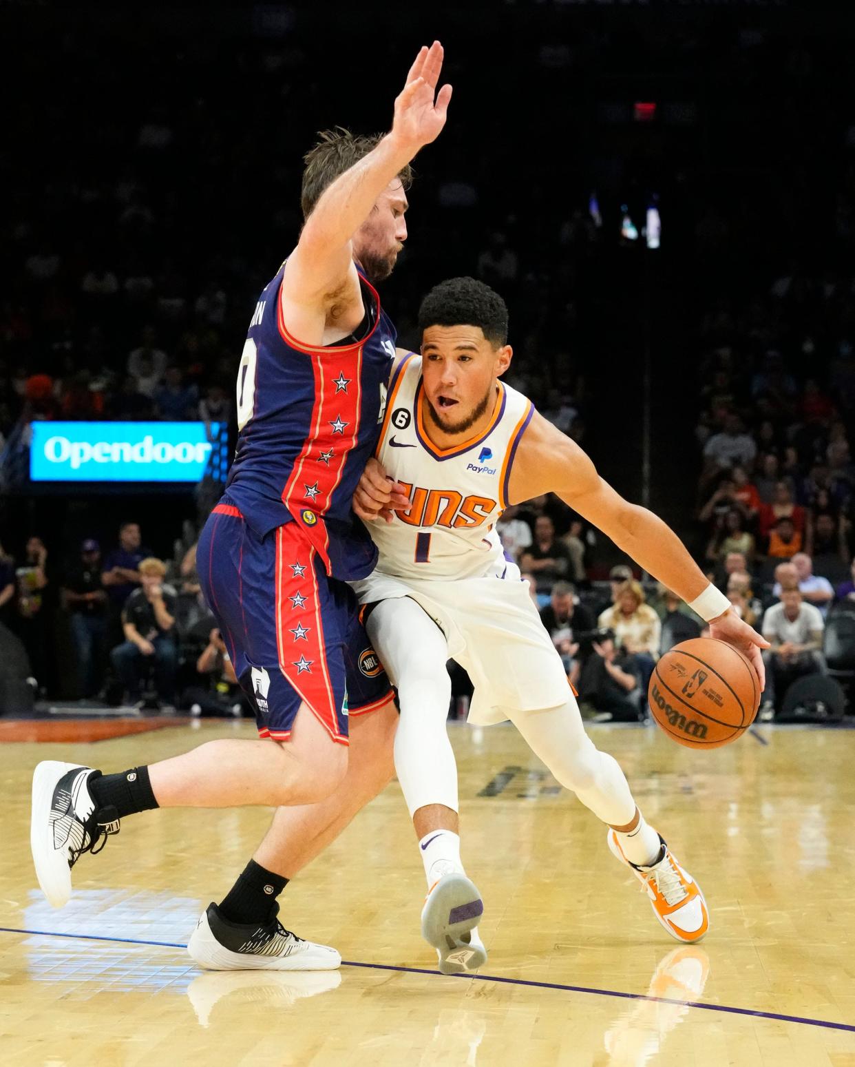 Oct 2, 2022; Phoenix, AZ, USA; Phoenix Suns guard Devin Booker (1) is pressured by Adelaide 36ers guard Mitch McCarron (10) at Footprint Center. Mandatory Credit: Rob Schumacher-Arizona Republic