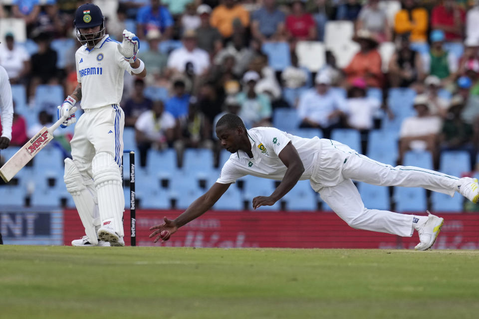 South Africa's bowler Kagiso Rabada, right, field off the ball as India's batsman Virat Kohli watches on during the third day of the test cricket match between South Africa and India, at Centurion Park, in Centurion, on the outskirts of Pretoria, South Africa, Thursday, Dec. 28, 2023. (AP Photo/Themba Hadebe)