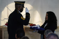 Sgt. Maj. Patrick Thomas, left, salutes the flag held by Executive Director Office of Army Cemeteries, Karen Durham-Aguilera, during a ceremony at the U.S. Army's Carlisle Barracks, in Carlisle, Pa., Wednesday, July 14, 2021. The disinterred remains of nine Native American children who died more than a century ago while attending a government-run school in Pennsylvania were headed home to Rosebud Sioux tribal lands in South Dakota on Wednesday after a ceremony returning them to relatives. (AP Photo/Matt Rourke)