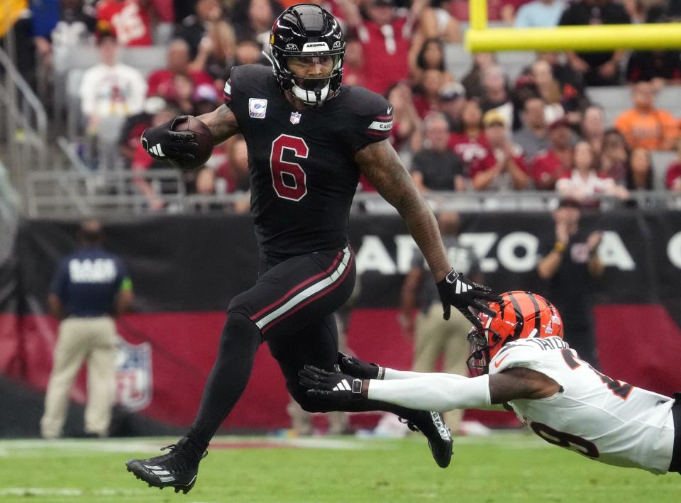 Arizona Cardinals running back James Conner (6) breaks away from Cincinnati Bengals cornerback Cam Taylor-Britt (29) at State Farm Stadium in Glendale on Oct. 8, 2023.