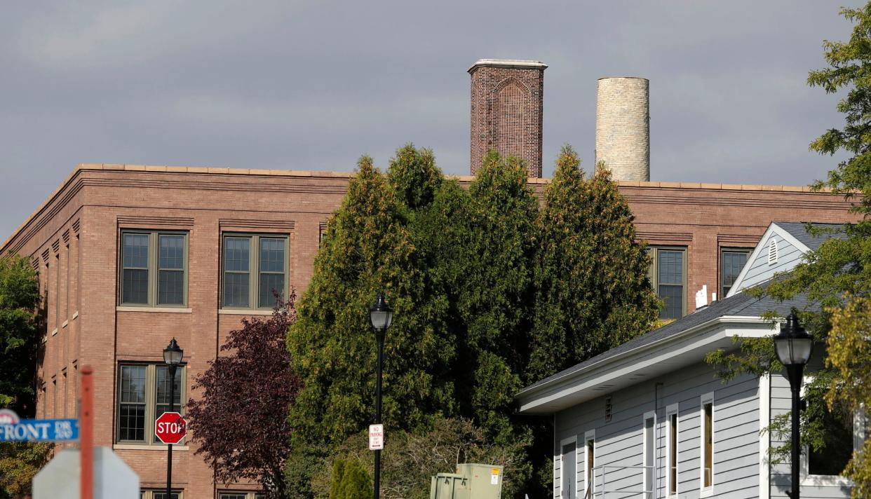 The Jung Apartment building complex’s smokestack, right, got a trim recently and now not near as tall as once was as seen, Monday, September 18, 2023, in Sheboygan, Wis.
