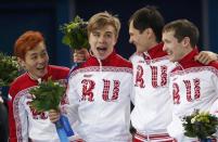 The winning Russian team celebrates on the podium during the flower ceremony for the men's 5,000 metres short track speed skating final relay race at the Iceberg Skating Palace in the Sochi 2014 Winter Olympic Games February 21, 2014. REUTERS/David Gray