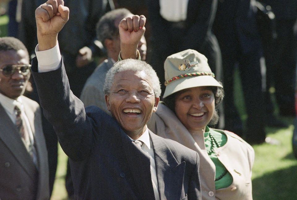 FILE - In this July 7, 1991, file photo, taken by South Africa photographer John Parkin, newly-elected African National Congress President Nelson Mandela and his wife, Winnie, greet supporters at an ANC rally. Parkin, who covered the country's anti-apartheid struggle, its first democratic elections, and the presidency of Nelson Mandela, has died Monday Aug. 23, 2021, at the age of 63 according to his daughter. (AP Photo/John Parkin, File)