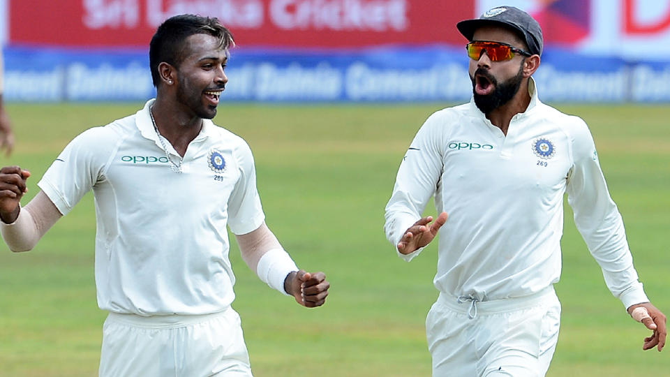 Hardik Pandya (L) celebrates a wicket with Virat Kohli. Image: LAKRUWAN WANNIARACHCHI/AFP/Getty Images)