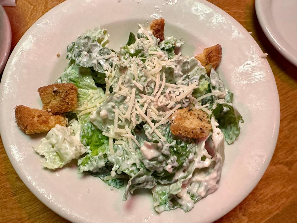Caesar salad with dressing, shredded Parmesan and croutons at Texas Roadhouse