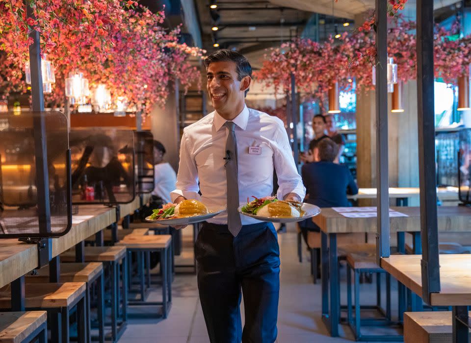 Chancellor Rishi Sunak serving customers at a Wagamama restaurant in central London after unveiling his