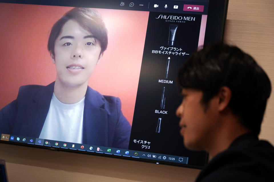 Naruhiko Ito, assistant brand manager of Brand Shiseido Group, demonstrates Shiseido released AR makeup filter for men to use for online meetings in Tokyo Thursday, April 15, 2021. A large personal care company, Shiseido, says one of its male makeup lines has seen double-digit growth during the coronavirus pandemic. Company officials give a similar reason: Men, confronted with the sight of their faces repeatedly during online meetings, want to improve what they see. (AP Photo/Eugene Hoshiko)