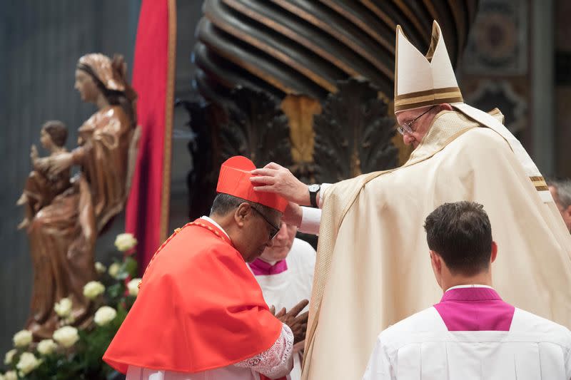 Pope Francis gives the traditional biretta hat to new cardinal Anthony Soter Fernandez of Malaysia during a consistory ceremony in Saint Peter's Basilica at the Vatican November 19, 2016. — Reuters pic