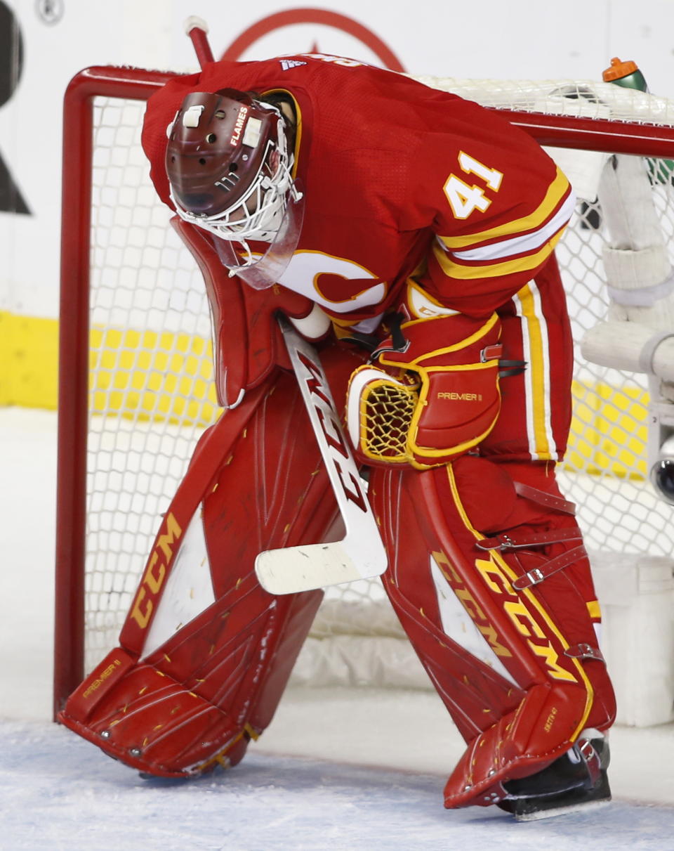 Calgary Flames goalie Mike Smith hangs his head late in the third period against the Colorado Avalanche during Game 5 of an NHL hockey first-round playoff series Friday, April 19, 2019, in Calgary, Alberta. Colorado won the game 5-1 and won the series. (Larry MacDougal/The Canadian Press via AP)