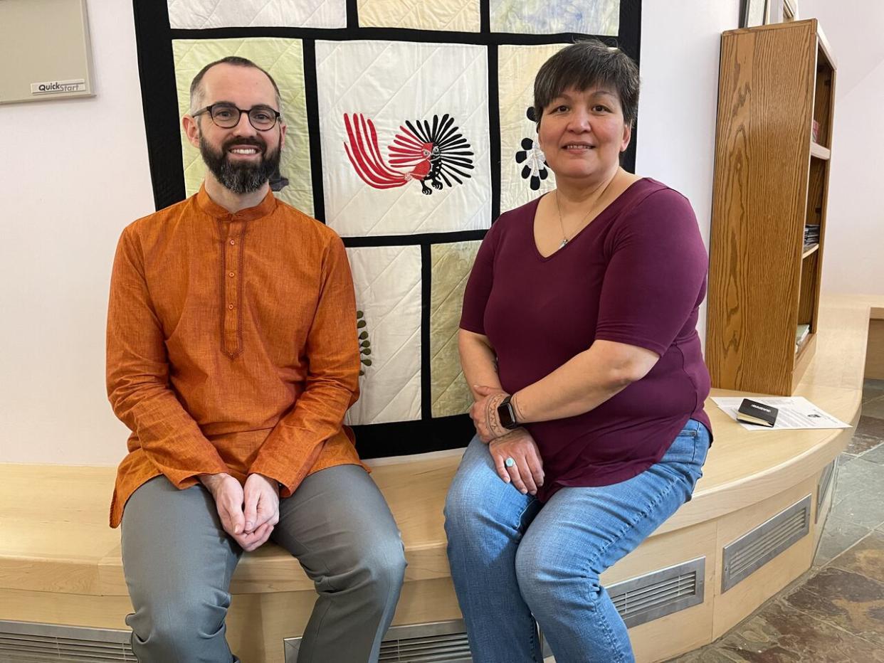 Chris Dow, left, is the rector and Rev. Ann Martha Keenainak, right, is the assistant priest of St. Jude's Anglican Church in Iqaluit. The church is still on the hook for $29,000, despite receiving a 75 per cent exemption from the city. (TJ Dhir/CBC - image credit)