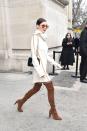 <p>In a Céline cream cowl neck sweater dress, Stuart Weitzman suede over-the-knee boots, Carrera aviator sunglasses and fur bag while leaving the Chanel couture show in Paris.</p>