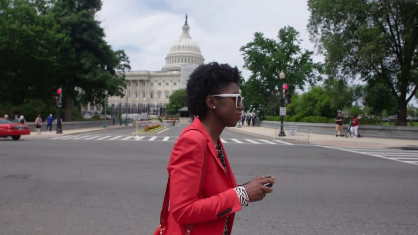 MIT researcher Joy Buolamwini walking in Washington, D.C. in the documentary "Coded Bias."