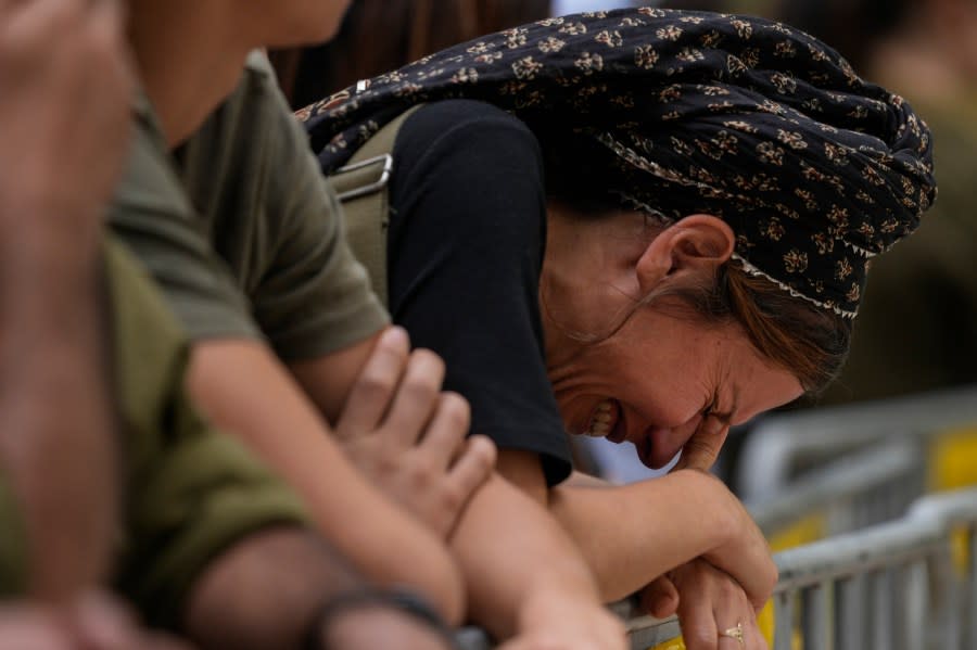 A woman cries during the funeral of Israeli Col. Roi Levy at the Mount Herzl cemetery in Jerusalem on Monday, Oct. 9, 2023. Col. Roi Levy was killed after Hamas militants stormed from the blockaded Gaza Strip into nearby Israeli towns. Israel’s vaunted military and intelligence apparatus was caught completely off guard, bringing heavy battles to its streets for the first time in decades. (AP Photo/Maya Alleruzzo)