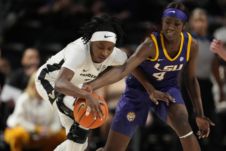 LSU guard Flau'jae Johnson (4) steals the ball from Vanderbilt guard Jordyn Cambridge, left, during the first half of an NCAA college basketball game Thursday, Feb. 8, 2024, in Nashville, Tenn. (AP Photo/George Walker IV)