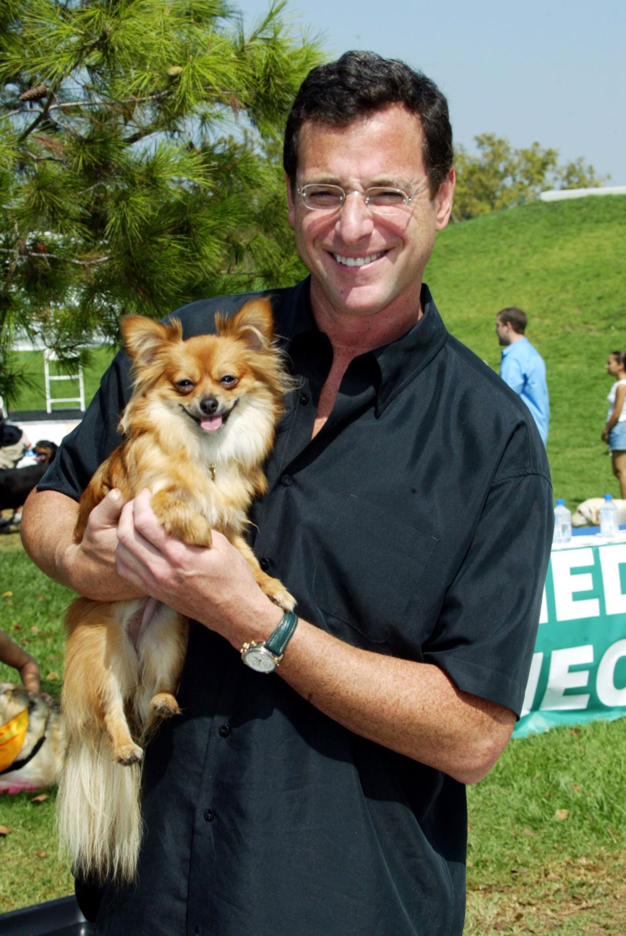 Comedian Bob Saget attends the Four Paws For A Cure dog walk at the La Brea Tar Pits on Sept. 14, 2003, in Los Angeles, Calif. The event benefits the National Childhood Cancer Foundation.