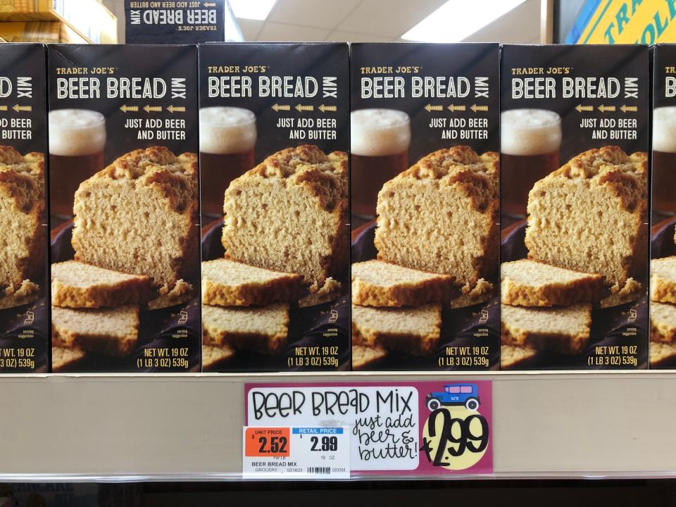 Boxes of Trader Joe's beer-bread mix on a shelf, with a price tag that reads $3.