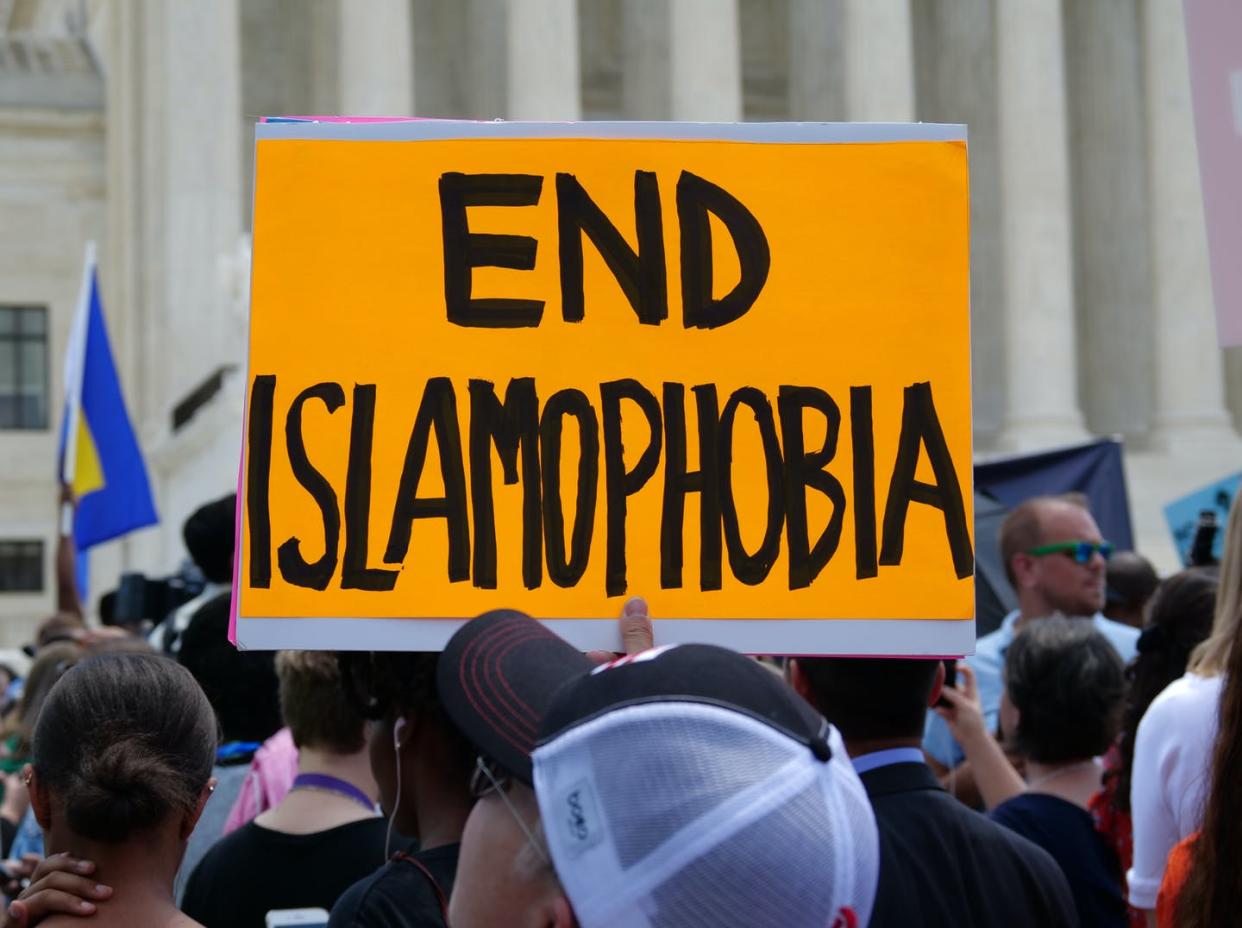 <span class="caption">Islamophobia in the media fed the support for the proposed Muslim travel ban. Here, a protestor holds an "End Islamophobia" sign at a rally opposing the ban at the U.S. Supreme Court on June 26, 2018. </span> <span class="attribution"><span class="source">(Shutterstock)</span></span>