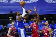 Los Angeles Lakers' LeBron James, second from left, goes up for a shot against Philadelphia 76ers' Furkan Korkmaz, from left, Tobias Harris and Ben Simmons during the first half of an NBA basketball game, Wednesday, Jan. 27, 2021, in Philadelphia. (AP Photo/Matt Slocum)
