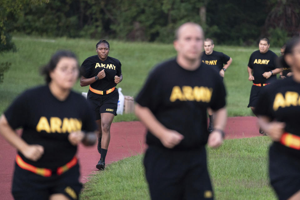 Students in the new Army prep course run around a track during physical training exercises at Fort Jackson in Columbia, S.C., Saturday, Aug. 27, 2022. The new program prepares recruits for the demands of basic training. (AP Photo/Sean Rayford)