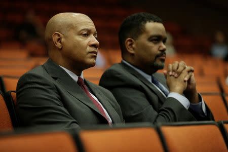 FILE PHOTO: Charlottesville Chief of Police Al Thomas (L) and Charlottesville City Manager Maurice Jones listen to speakers during a public forum hosted by the Department of Justice Community Relations Service after a rally by far-right demonstrators led to the death of a counter protester in Charlottesville, Virginia, U.S., August 27, 2017. REUTERS/Joshua Roberts