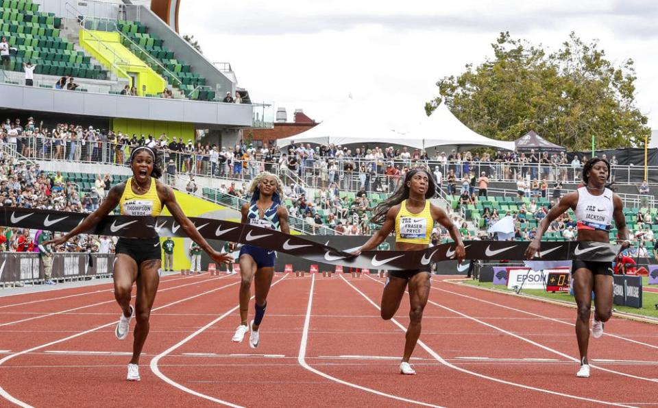 Jamaica’s Elaine Thompson-Herah, left, wins the 100 meters, as American track and field sprinter Sha’carri Richardson, second from left, also competes, Saturday, Aug. 21, 2021, at the Prefontaine Classic track and field meet in Eugene, Ore. (AP Photo/Thomas Boyd)