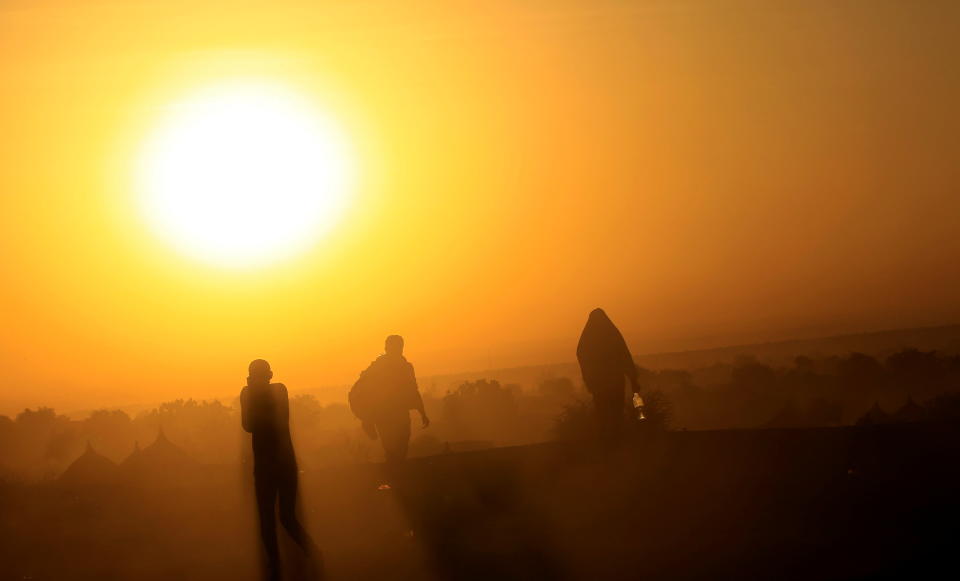 Ethiopians, who fled the ongoing fighting in Tigray region, walk at dawn within Hamdayet village on the Sudan-Ethiopia border, in the eastern Kassala state, Sudan. (Mohamed Nureldin Abdallah/Reuters)