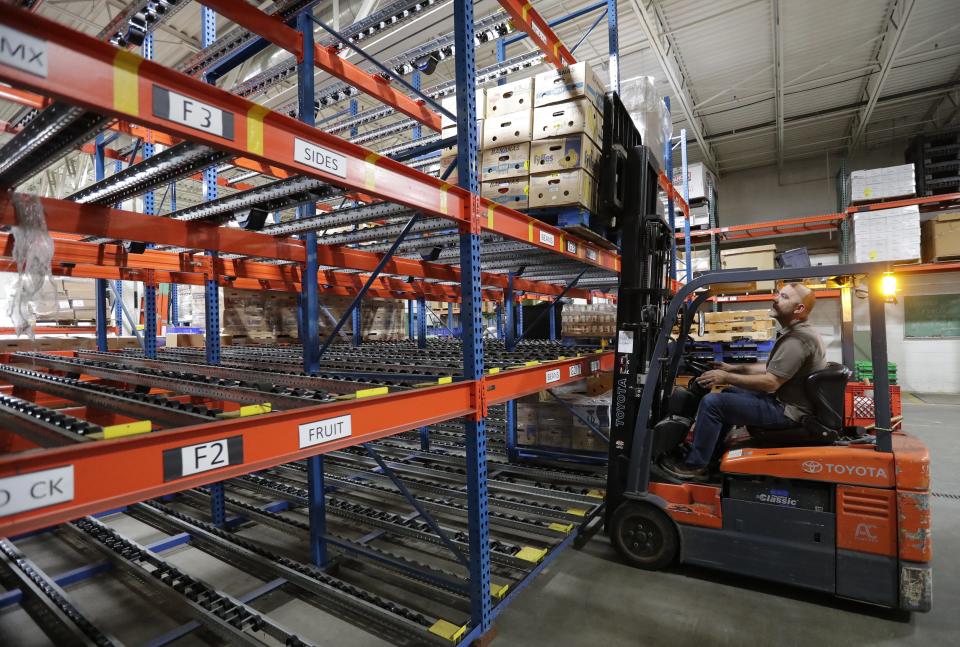 Director of Operations Scott Schefe stocks a pallet of donated food items Thursday, September 29, 2022, at St. Joseph Food Program in Menasha, Wis. According to Schefe, the warehouse is only at ten percent of normal capacity.