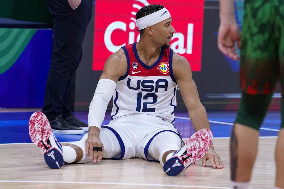 U.S. forward Josh Hart (12) sits on the court after a missed shot against Lithuania during the second half of a Basketball World Cup second-round match in Manila, Philippines Sunday, Sept. 3, 2023.(AP Photo/Michael Conroy)