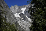 The Planpincieux glacier, located in the Alps on the Grande Jorasses peak of the Mont Blanc massif, is seen from Val Ferret, a popular hiking area on the south side of the Mont Blanc, near Courmayeur, northern Italy, Friday, Aug. 7, 2020. Some 70 people were evacuated Thursday in the valley below the glacier and roads closed after the threat of collapse the the fast-moving melting glacier is posing to the picturesque valley near the Alpine town of Courmayeur. (Claudio Furlan/LaPresse via AP)