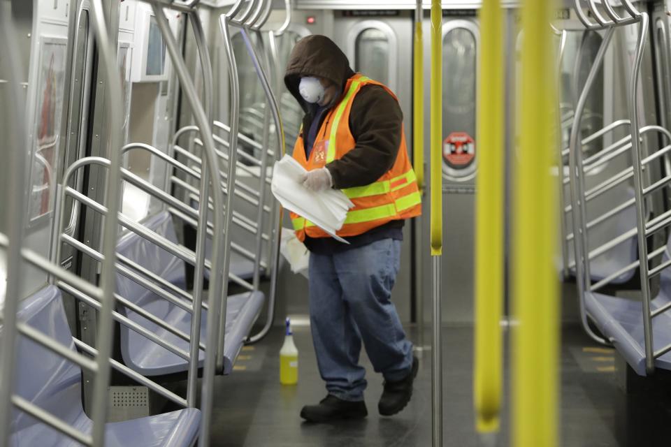 A New York Metropolitan Transportation authority worker disinfects a subway train at the Coney Island Stillwell Avenue Terminal, in the Brooklyn borough of New York.