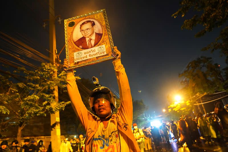 A demonstrator holds up a portrait of Thailand's late King Bhumibol Adulyadej during an anti-government in Bangkok