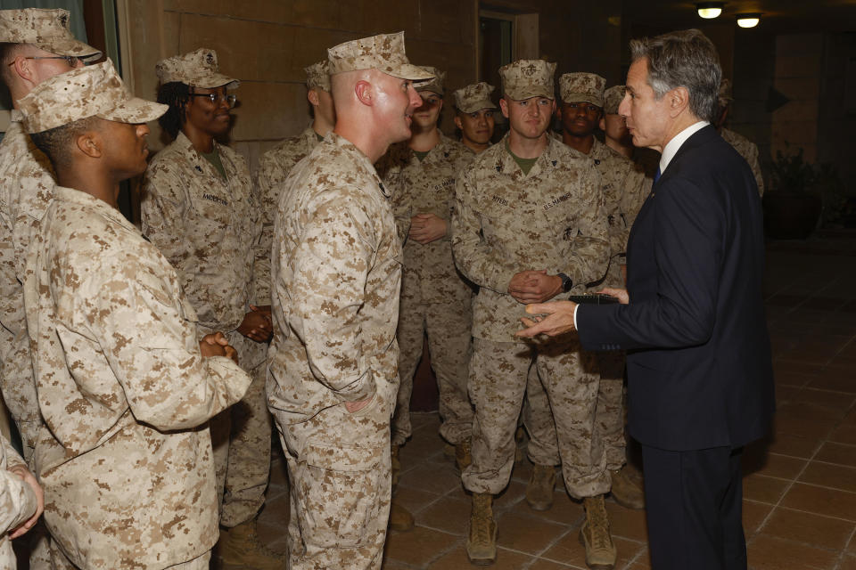 Secretary of State Antony Blinken exchanges challenge coins with the U.S. Marine Corps embassy security guard detachment in Baghdad, Iraq, on Nov. 5, 2023. / Credit: Jonathan Ernst / AP