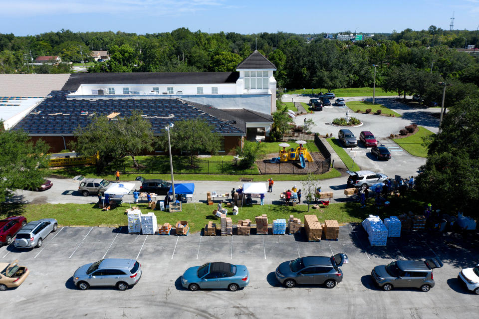 Cars line up to receive food from the Second Harvest Food Bank of Central Florida at Carter Tabernacle Christian Methodist Episcopal Church on Aug. 8, 2020 in Orlando.<span class="copyright">Paul Hennessy—NurPhoto/Getty Images</span>